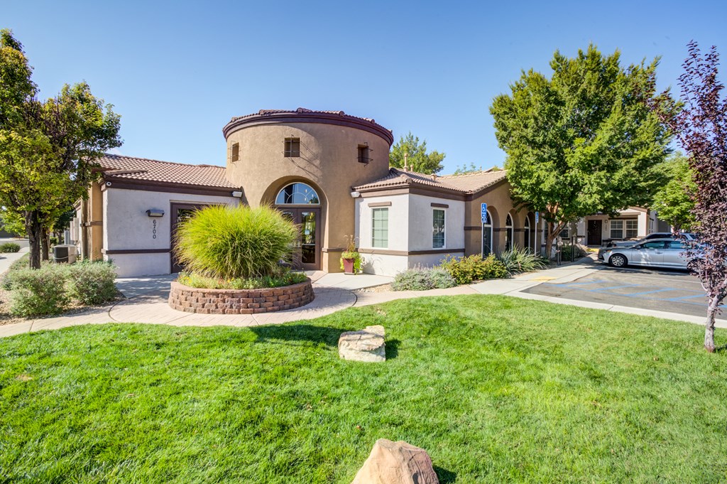 a house with a driveway and a lawn in front of it